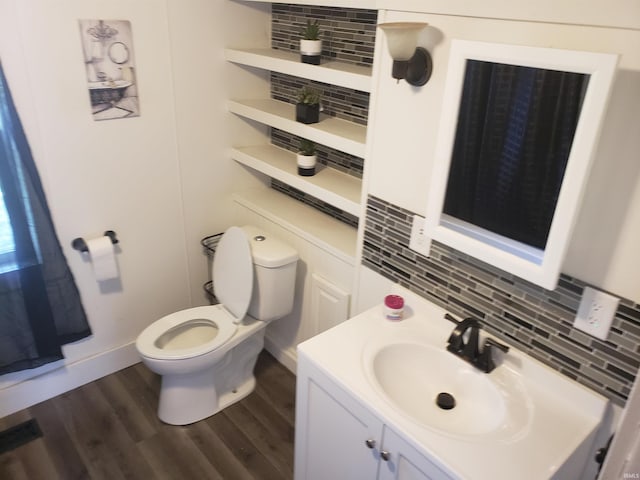 9067 W 290, Delphi, IN 46923 - half bathroom featuring tasteful backsplash, toilet, vanity, and wood finished floors