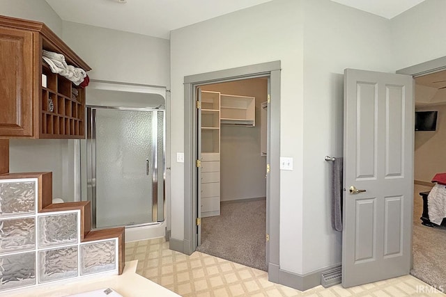 full bathroom featuring tile patterned floors, a stall shower, and baseboards