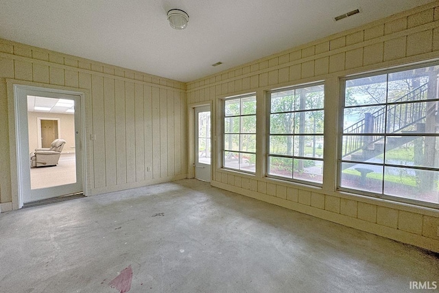unfurnished room featuring concrete floors