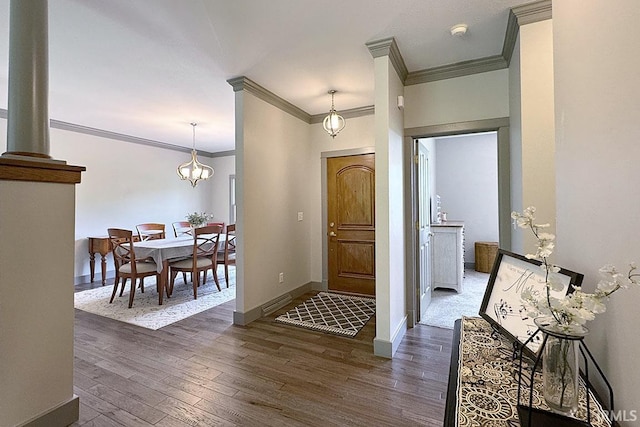 entryway featuring crown molding, dark wood-style flooring, and baseboards