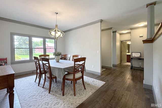 dining area featuring ornamental molding, a chandelier, dark wood finished floors, and baseboards