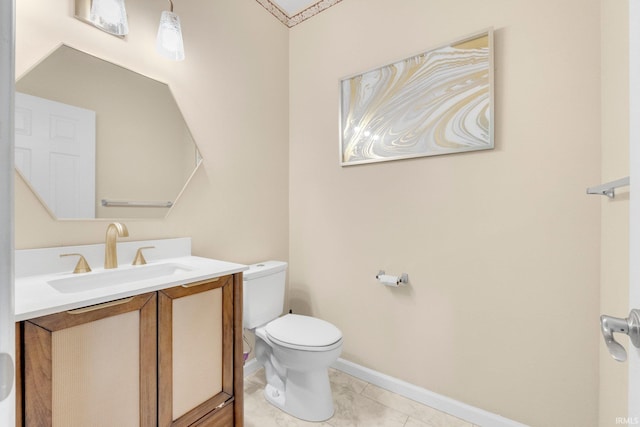 bathroom featuring toilet, vanity, baseboards, and marble look tiles