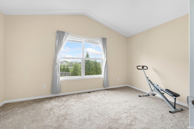 workout area with carpet floors, vaulted ceiling, and baseboards