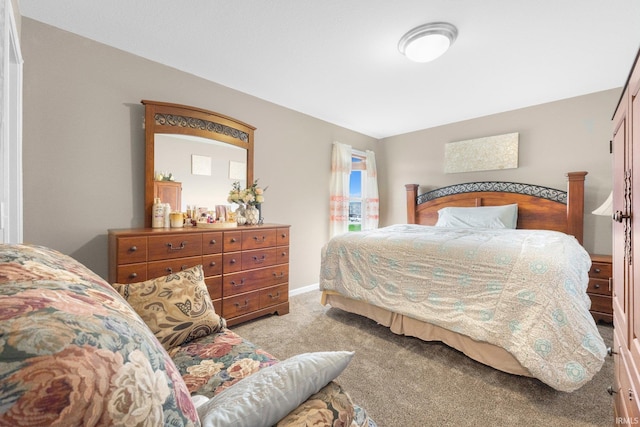 carpeted bedroom featuring baseboards