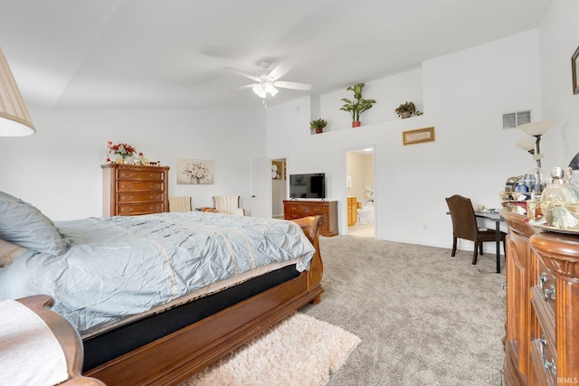 carpeted bedroom featuring vaulted ceiling, baseboards, ensuite bathroom, and ceiling fan