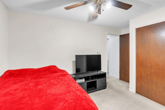 bedroom featuring light colored carpet, ceiling fan, and baseboards