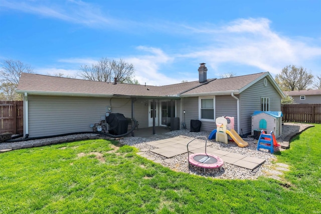 back of property featuring a patio, an outdoor fire pit, and a shingled roof