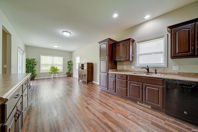 1592 Breckenridge Pass, Fort Wayne, IN 46845 - kitchen featuring black dishwasher, a sink, light wood finished floors, dark brown cabinetry, and recessed lighting