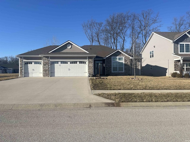 1592 Breckenridge Pass, Fort Wayne, IN 46845 - view of front of home featuring stone siding, a garage, and driveway
