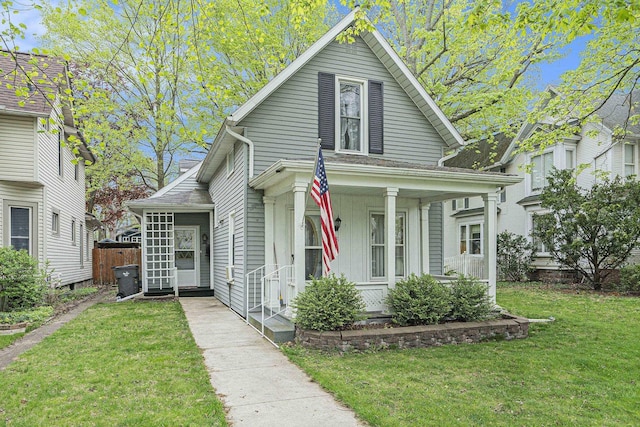 view of front of property with covered porch and a front lawn