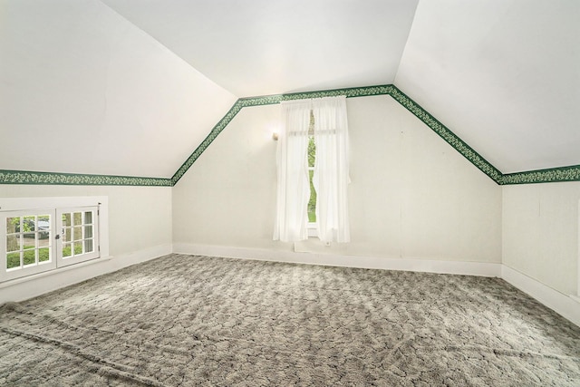 additional living space featuring lofted ceiling, carpet floors, and baseboards