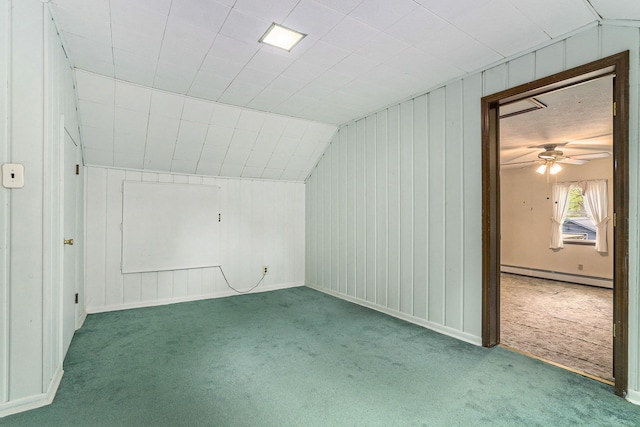 bonus room featuring a baseboard radiator, carpet flooring, lofted ceiling, a ceiling fan, and wood walls