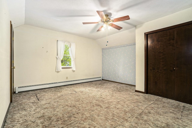 unfurnished bedroom with baseboard heating, vaulted ceiling, carpet flooring, baseboards, and ceiling fan