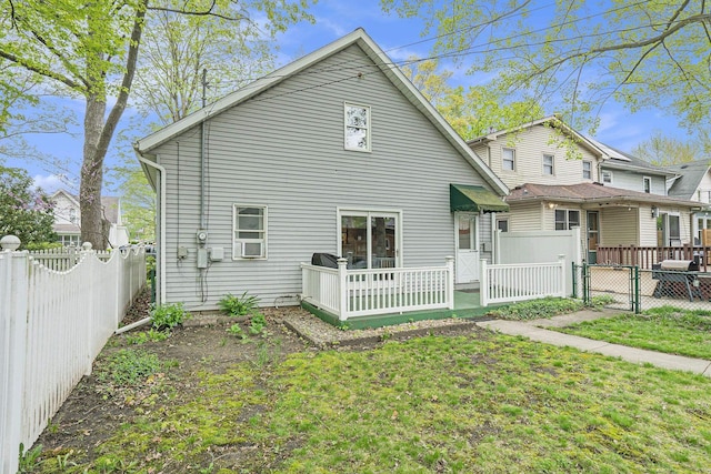 rear view of property featuring a gate and cooling unit