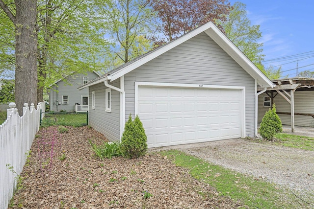 detached garage featuring fence