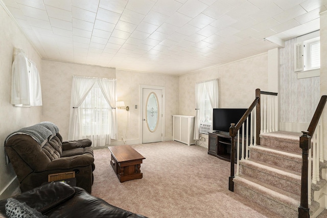 living area featuring carpet floors, stairway, and ornamental molding