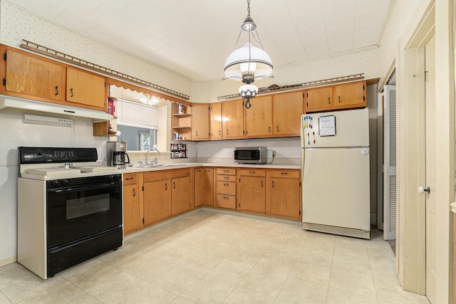 kitchen with range with electric stovetop, freestanding refrigerator, under cabinet range hood, stainless steel microwave, and a sink