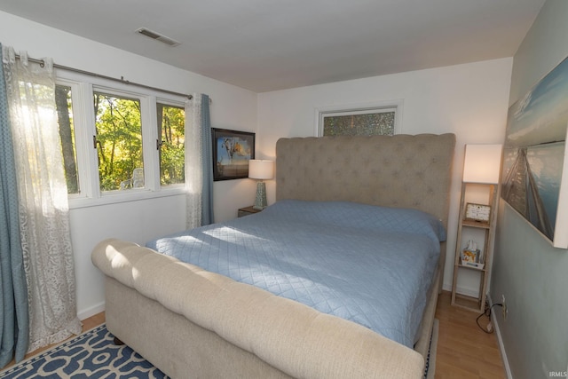 bedroom with wood finished floors and baseboards