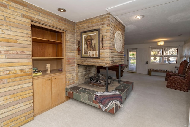 living area featuring light carpet and a fireplace