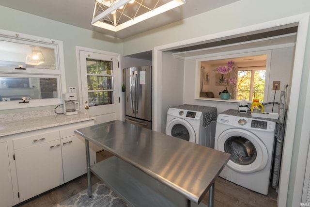washroom with washing machine and dryer, dark wood finished floors, and a chandelier