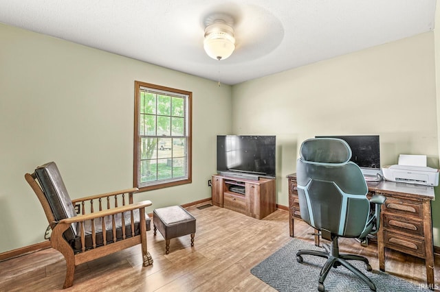 office space with wood finished floors, ceiling fan, and baseboards