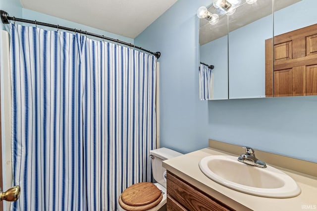 bathroom featuring vanity, toilet, and a shower with shower curtain
