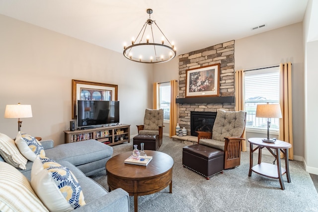 living area featuring plenty of natural light, a chandelier, and light colored carpet