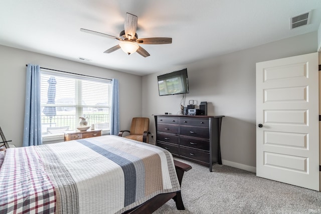 bedroom with light carpet, a ceiling fan, and baseboards