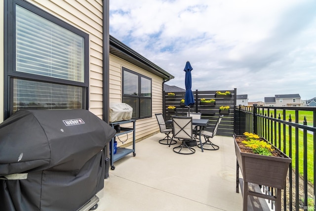 view of patio / terrace featuring outdoor dining space, grilling area, and fence