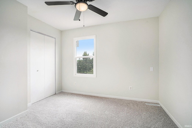 unfurnished bedroom featuring carpet floors, a closet, and baseboards