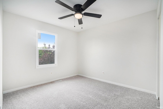 spare room with baseboards, carpet flooring, and a ceiling fan