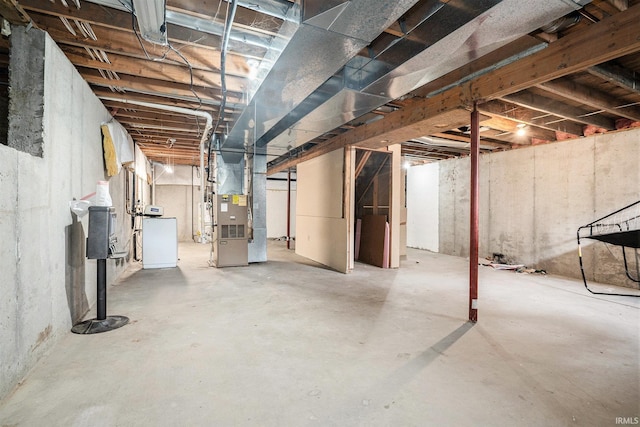 unfinished basement featuring heating unit