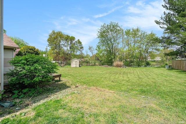view of yard featuring a storage shed and an outdoor structure