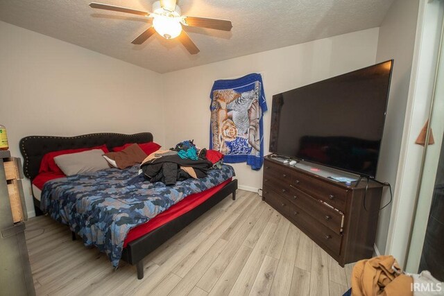 1831/1833 S Maxwell St, Bloomington, IN 47401 - bedroom with wood finished floors, a textured ceiling, and a ceiling fan