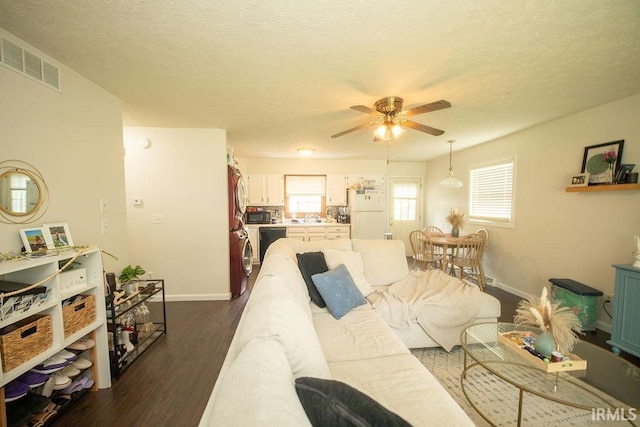 1831/1833 S Maxwell St, Bloomington, IN 47401 - living room featuring a ceiling fan, baseboards, dark wood finished floors, washer / clothes dryer, and a textured ceiling