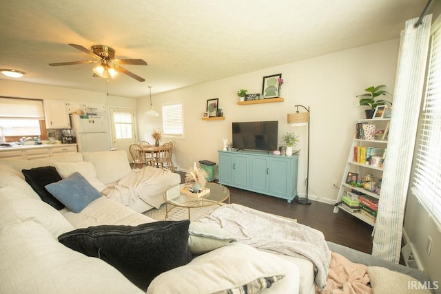 1831/1833 S Maxwell St, Bloomington, IN 47401 - living room with dark wood-style floors, ceiling fan, and baseboards