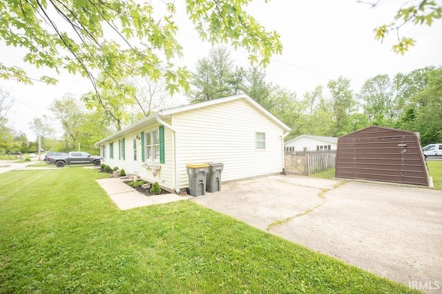 1831/1833 S Maxwell St, Bloomington, IN 47401 - view of side of home featuring a storage shed, an outbuilding, and driveway
