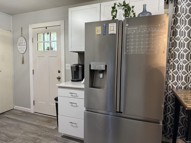 2823 Hillside Dr, Bedford, IN 47421 - kitchen featuring stainless steel fridge with ice dispenser, wood finished floors, white cabinetry, light countertops, and baseboards