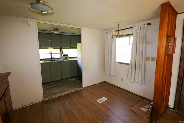 1008 W Elm St, Hartford City, IN 47348 - unfurnished dining area featuring a sink and dark wood-style floors