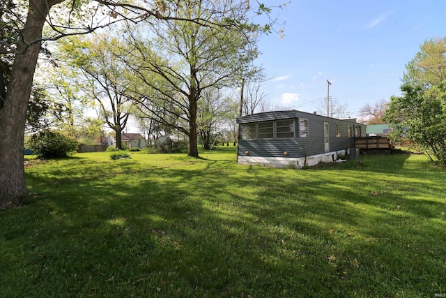 1008 W Elm St, Hartford City, IN 47348 - view of grassy yard featuring a deck and central air condition unit