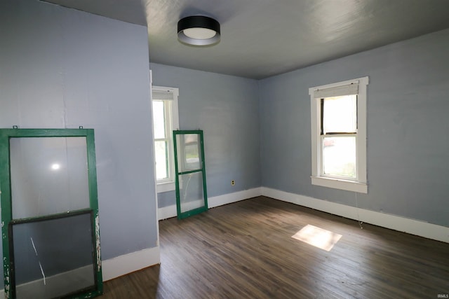 1008 W Elm St, Hartford City, IN 47348 - unfurnished room with baseboards and dark wood-type flooring