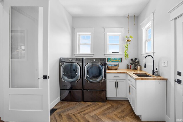 8086 Shepardson Creek Dr, Lafayette, IN 47905 - clothes washing area featuring cabinet space, washing machine and dryer, and plenty of natural light