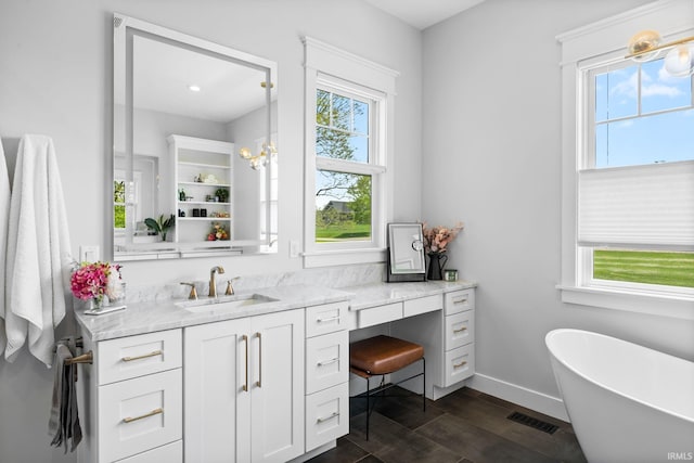 8086 Shepardson Creek Dr, Lafayette, IN 47905 - bathroom featuring vanity, a freestanding bath, wood finished floors, and baseboards