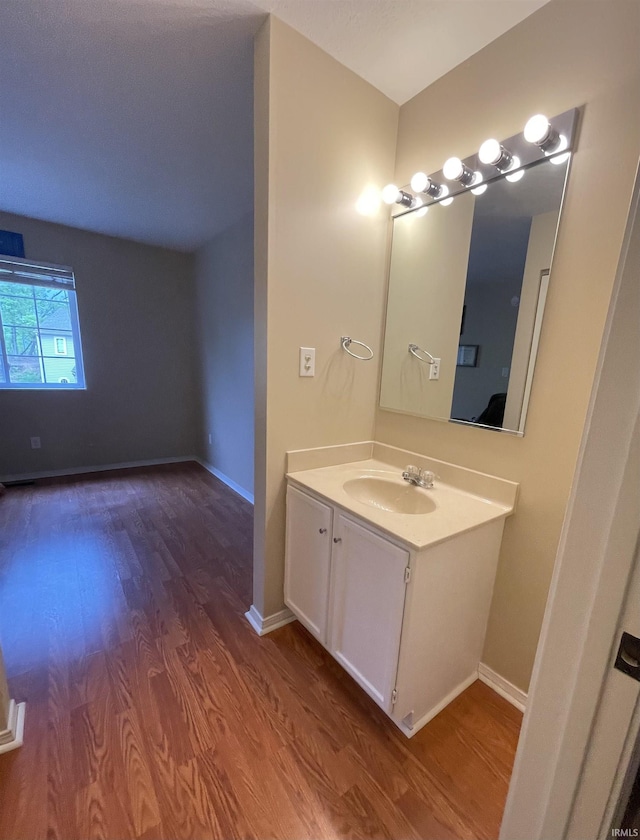 620 Bayberry Ct, Bloomington, IN 47401 - bathroom with wood finished floors, vanity, and baseboards