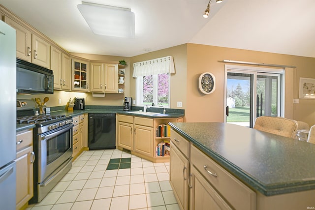 kitchen with black appliances, open shelves, dark countertops, and healthy amount of natural light