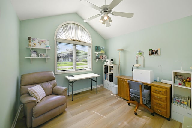 office space with light wood finished floors, a ceiling fan, lofted ceiling, and baseboards