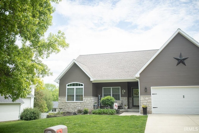 3417 S Tulip Ave, Bloomington, IN 47403 - view of front facade with a front lawn, driveway, roof with shingles, stone siding, and covered porch
