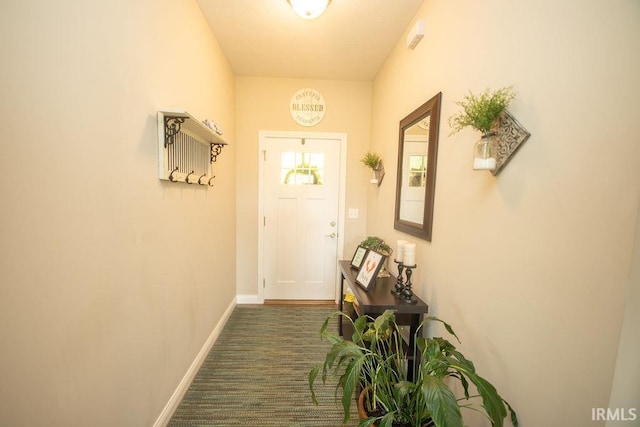 3417 S Tulip Ave, Bloomington, IN 47403 - doorway to outside with baseboards and dark colored carpet