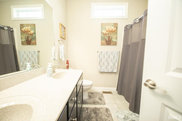 3417 S Tulip Ave, Bloomington, IN 47403 - bathroom featuring toilet, double vanity, tile patterned floors, baseboards, and a shower with shower curtain