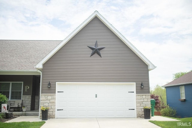 3417 S Tulip Ave, Bloomington, IN 47403 - view of front of property with stone siding, driveway, and an attached garage